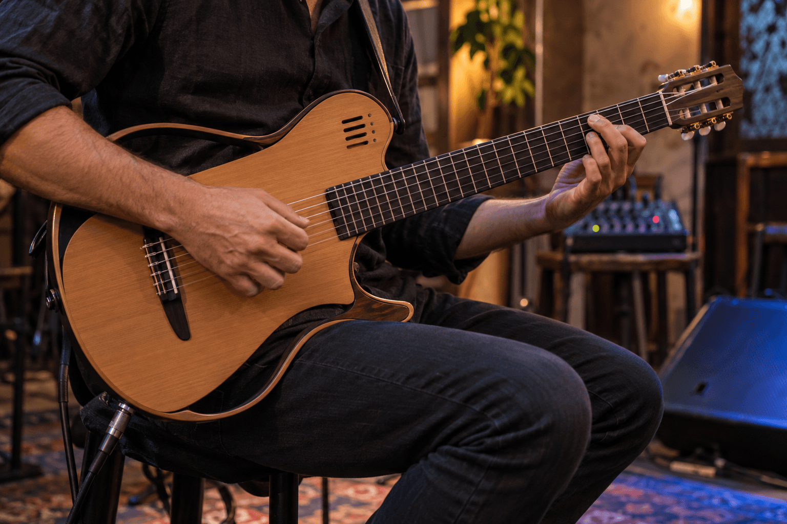 Músico toca um violão flat de nylon de corpo fino, com cabo ligado ao instrumento